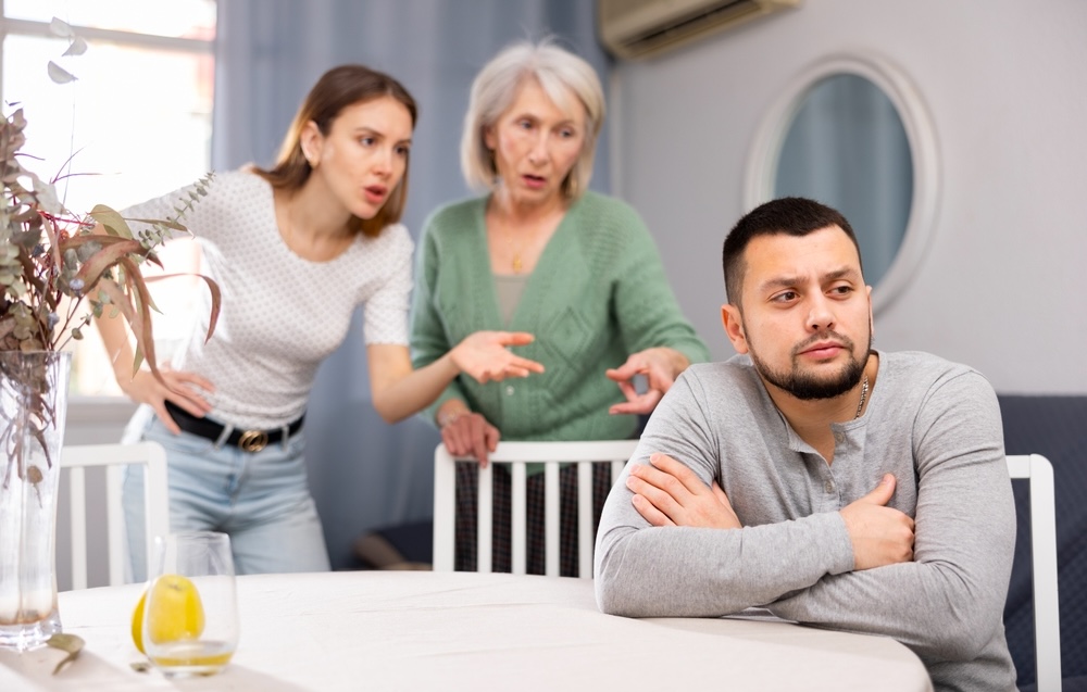 Family fighting with one adult son trying to avoid the fight