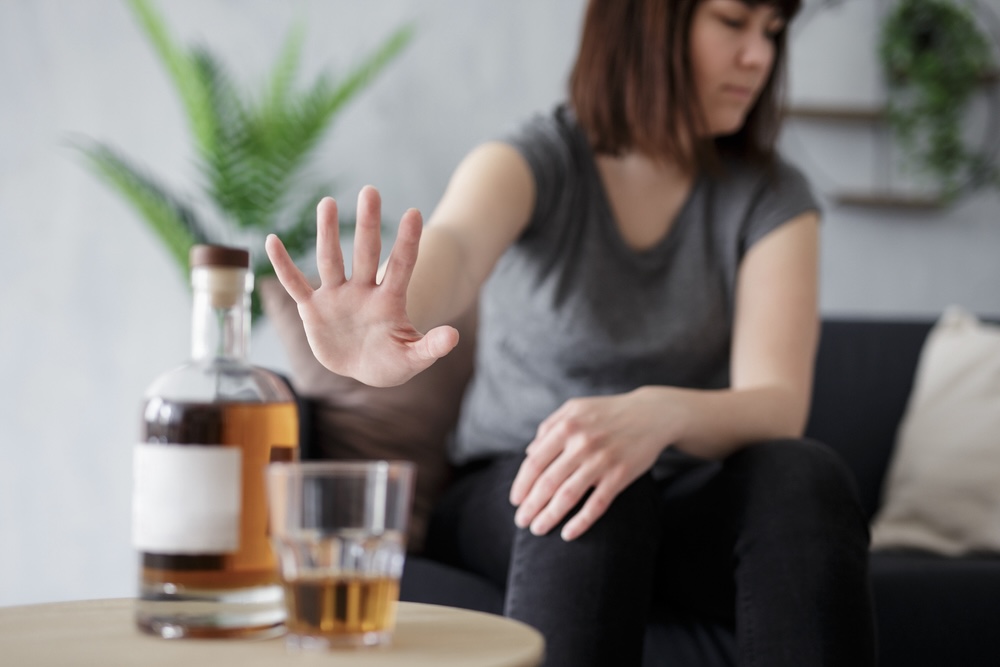 Woman refusing to drink whiskey