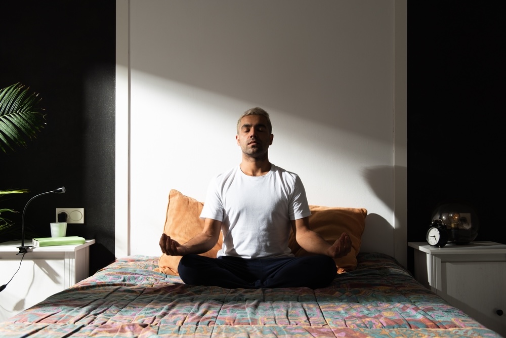 Man meditating becoming present in his daily life while in addiction recovery