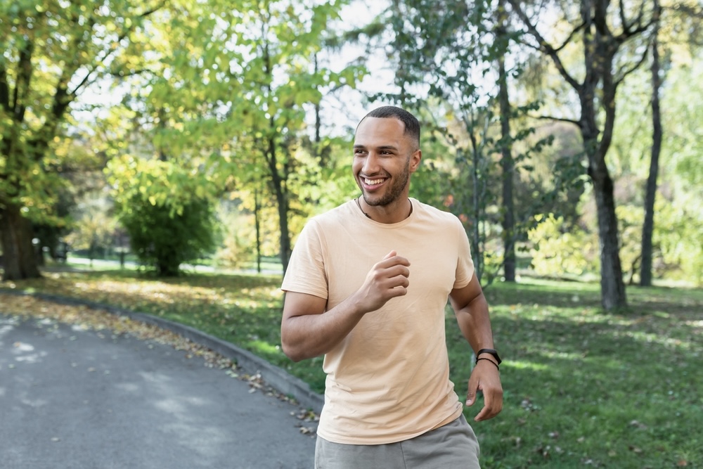 Sporty man jogging outdoors