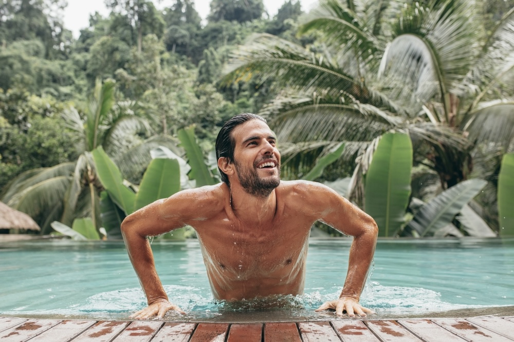 Man getting up from the swimming pool