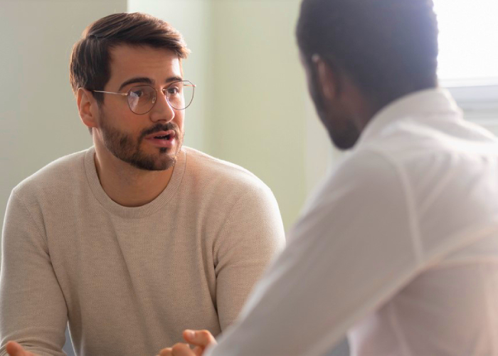 Worried alcohol patient talking to his therapist