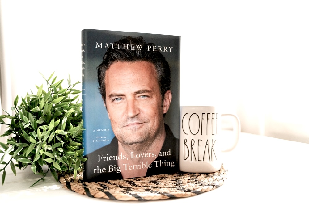 Mathew Perry’s memoir on a table with a coffee mug