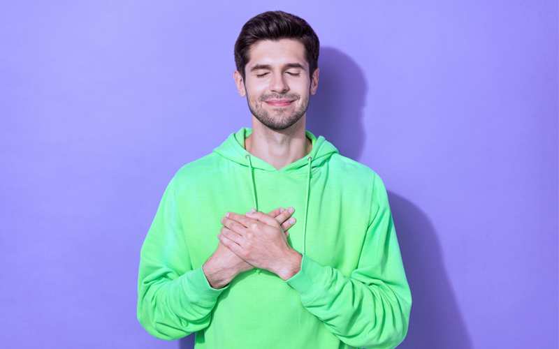 A calm man wearing green sweatshirt who is in addiction recovery