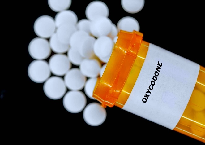 Oxycodone Rx medical pills in plactic Bottle with tablets.