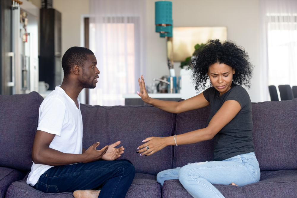 Woman holding her hand up to stop her partner from talking anymore