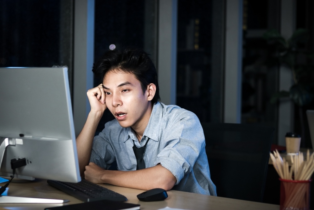 Man overloaded with work feeling stressed